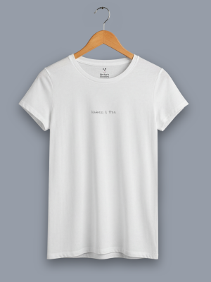 women's 'kindness is free' classic fit white t shirt on a hanger
